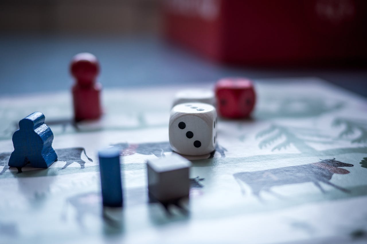 heros-img Close-up view of board game pieces and dice on a game board. Perfect for recreation and strategy themes.